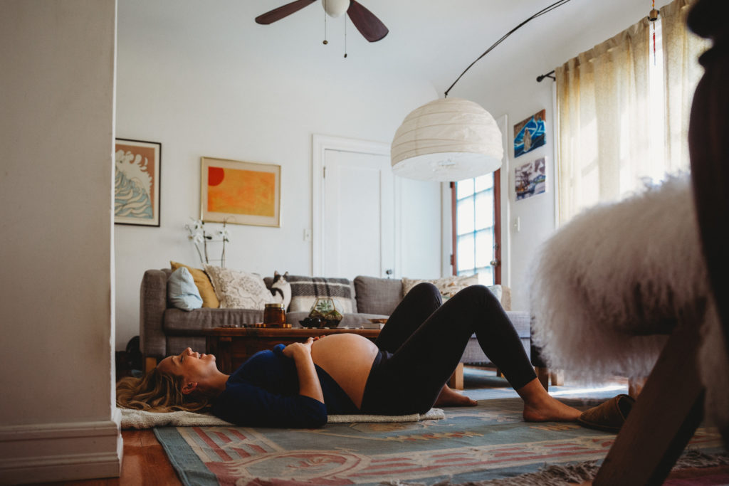 a pregnant mom practices yoga 