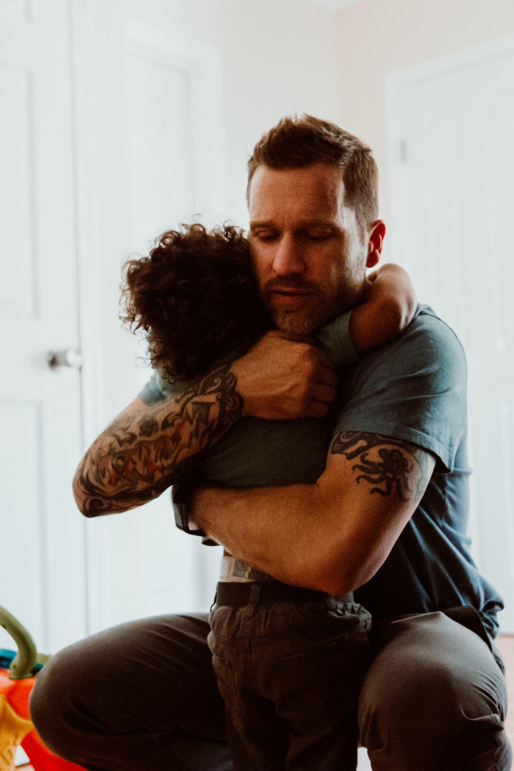 A dad hugs his young son, Highland Park, Los Angeles, CA