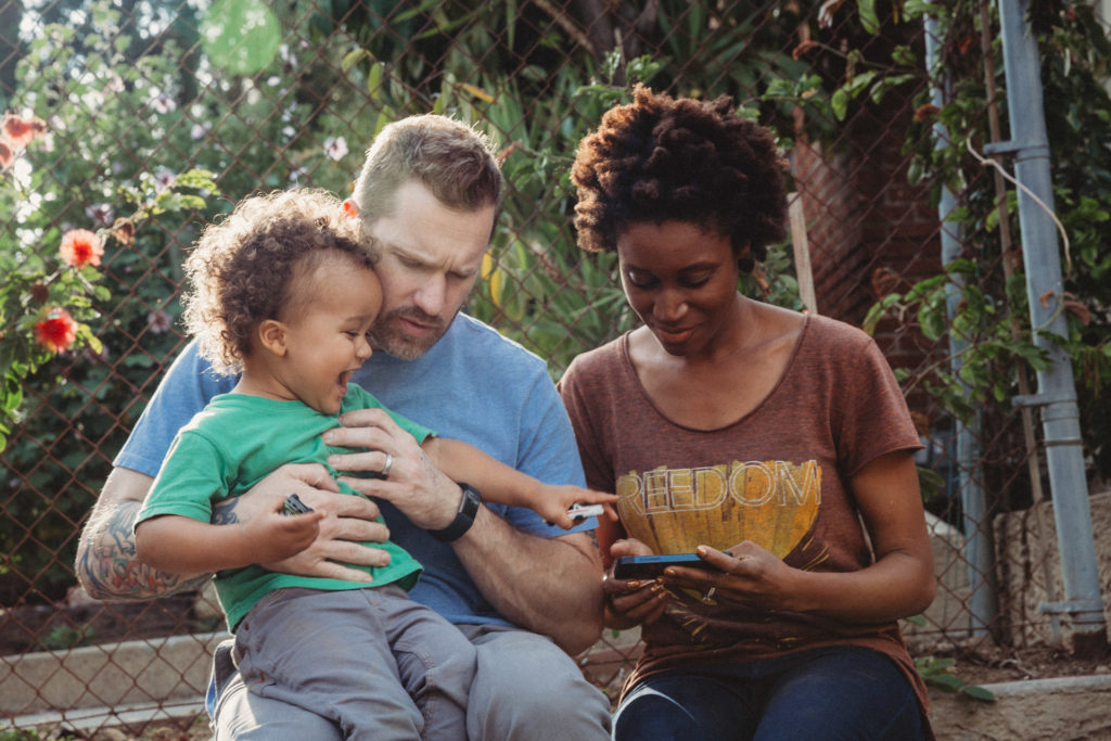 Mom, dad, toddler hanging out outside