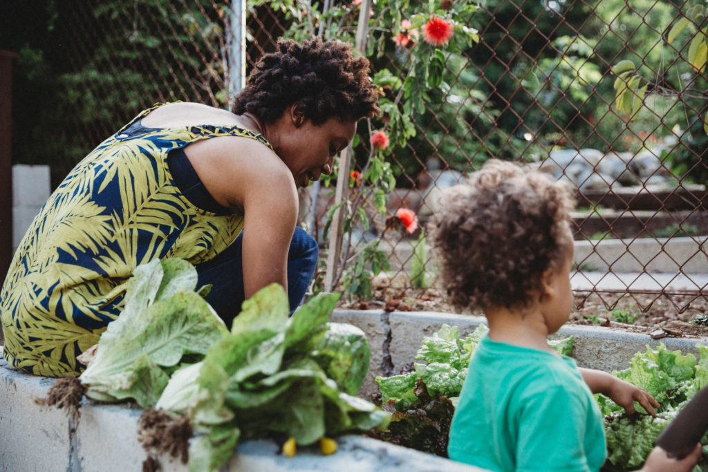 Mom and toddler gardening outside