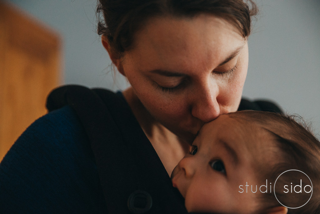 Mama kissing baby's head, Los Angeles, CA