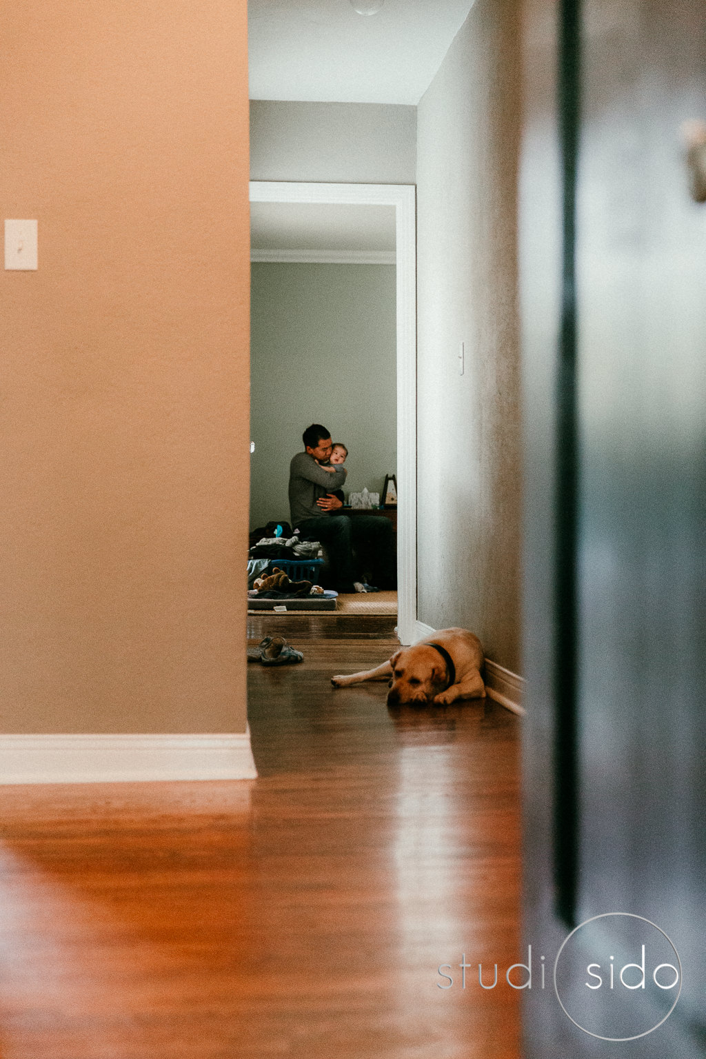 Daddy holding baby and trying to get him to sleep, Los Angeles, CA