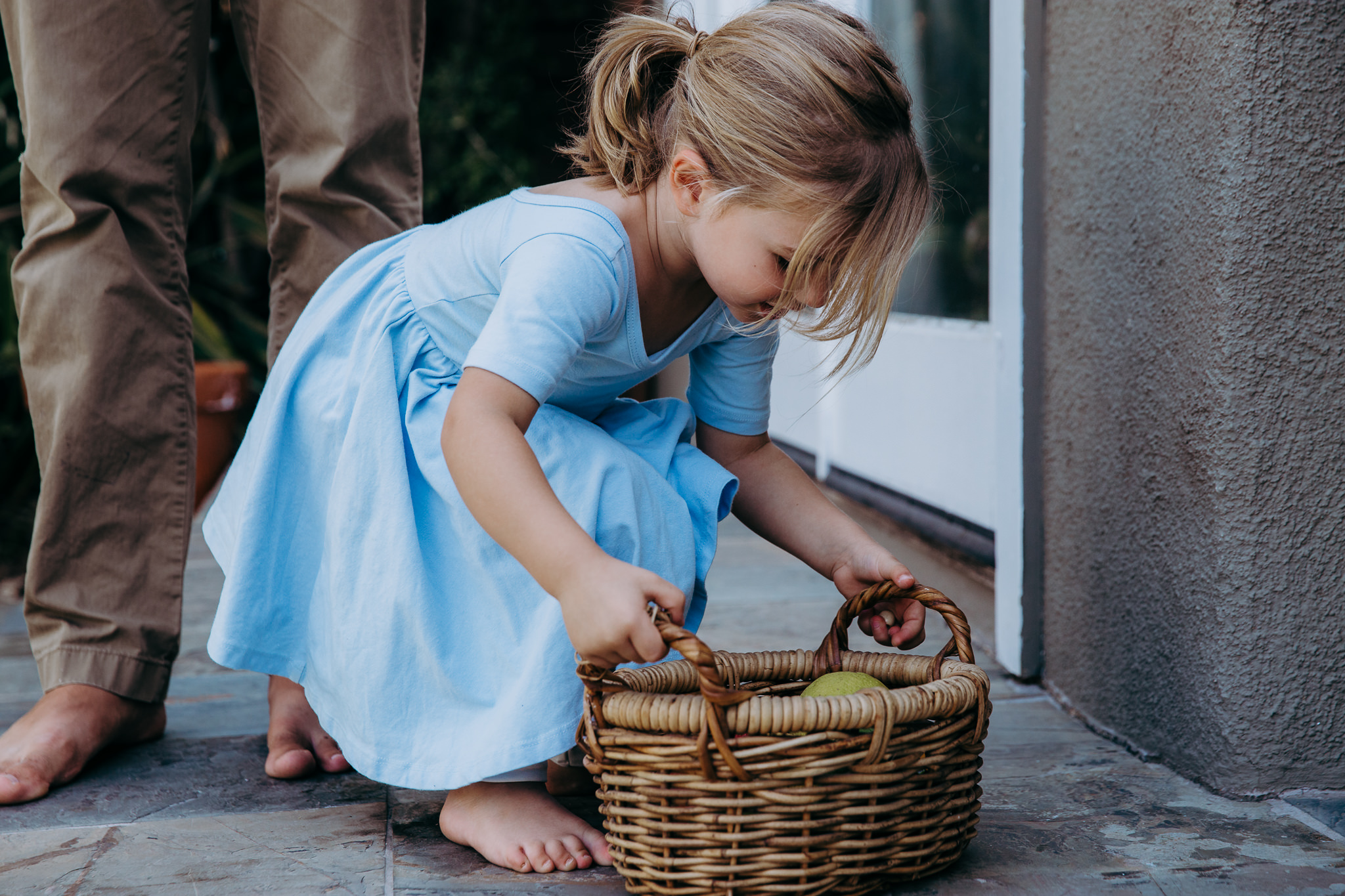 little girl picks up a big basket - Atwater Village, CA