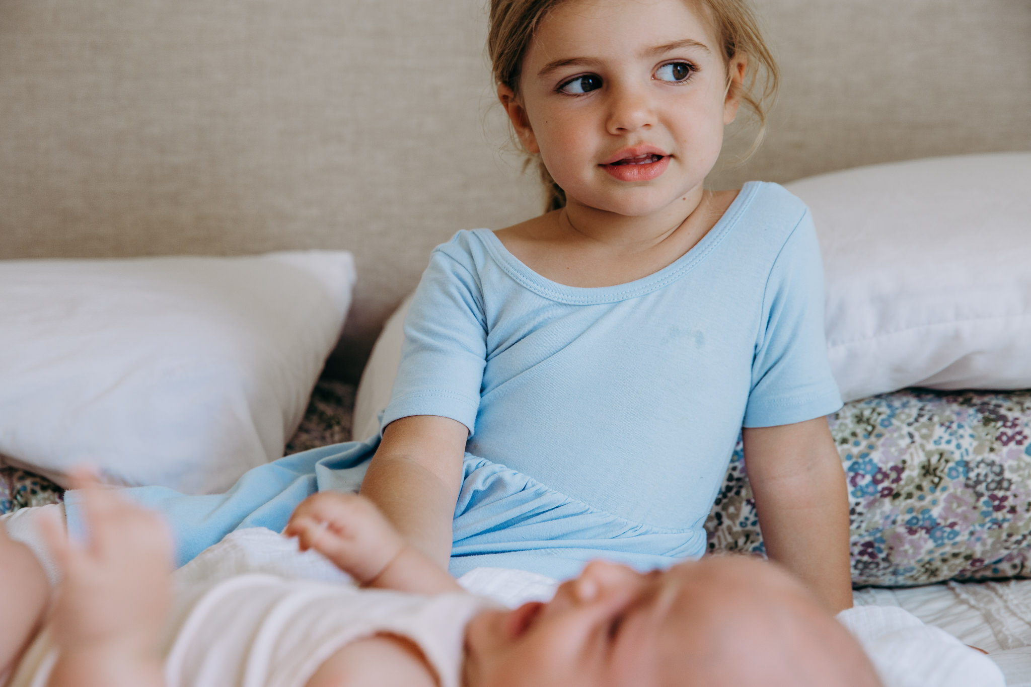 little girl with her baby sister on a bed - Atwater Village, CA