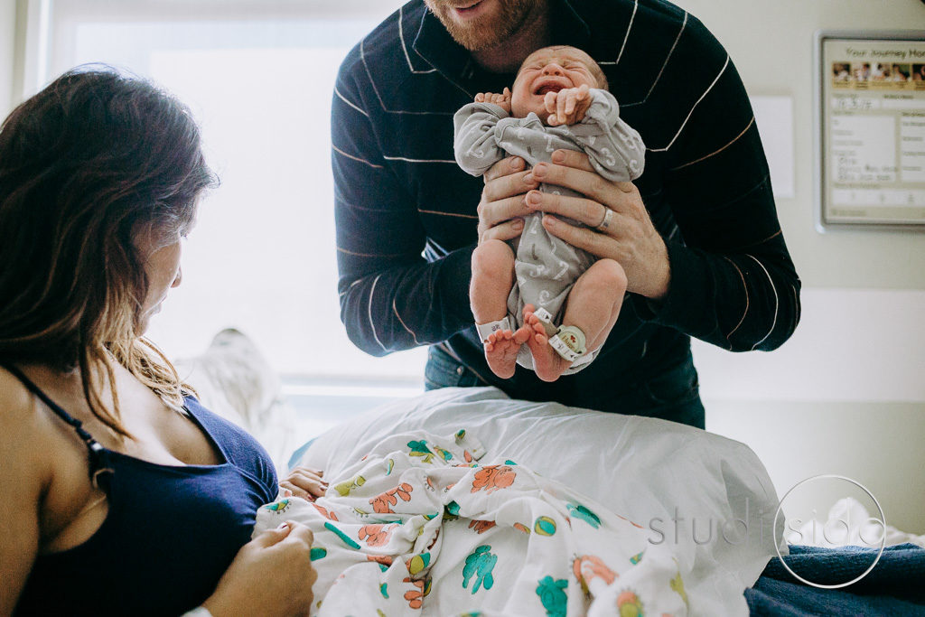 Dad lifts newborn baby at Kaiser Hospital Hollywood