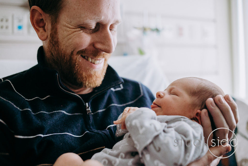 Dad smiles at baby