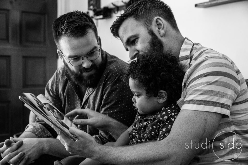 A family reads a book together in West Hollywood, CA.