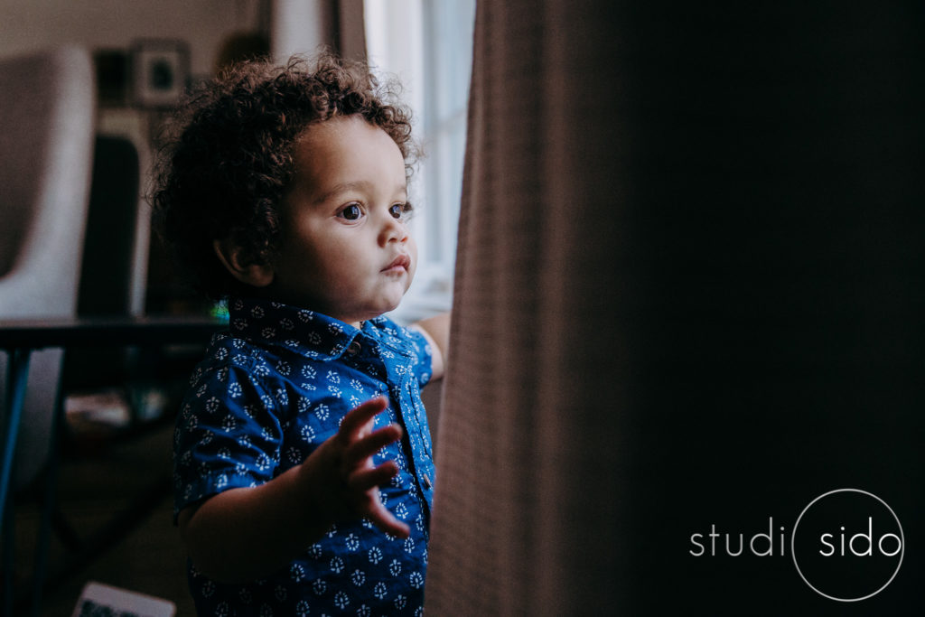 A boy looks out the window in West Hollywood, CA