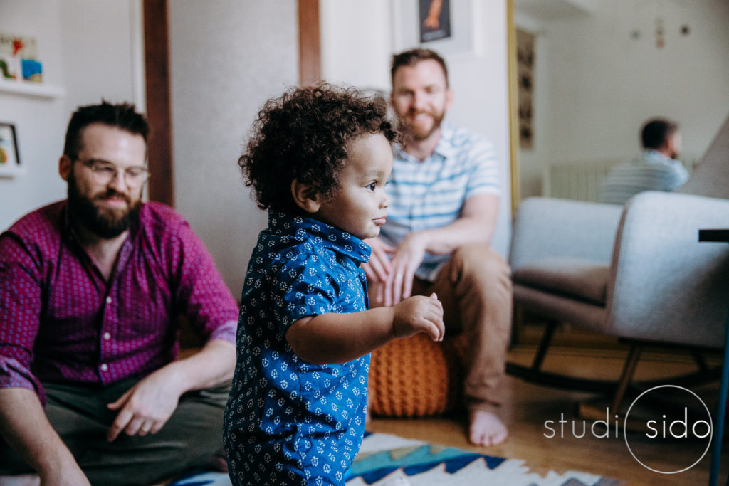 A boy and his dads hang out in his bedroom in West Hollywood, CA.