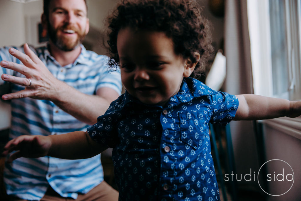 A boy and his dad plays hide and seek in West Hollywood, CA.