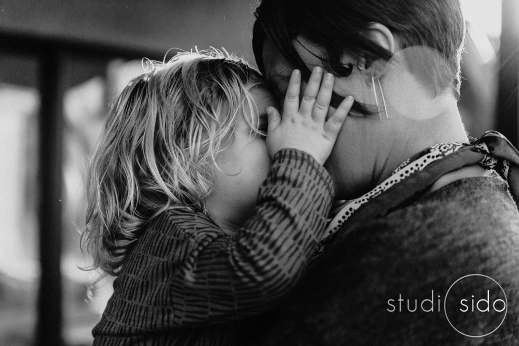 Little boy with hands on his mom's face