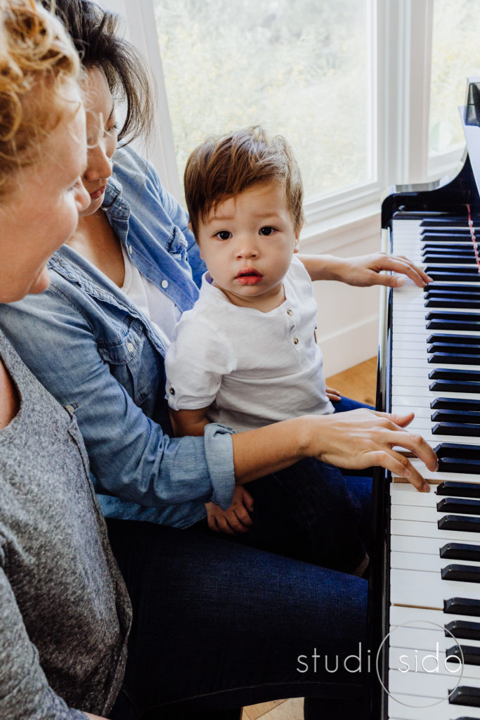 toddler on his mom's lap at their piano in Los Angeles, CA