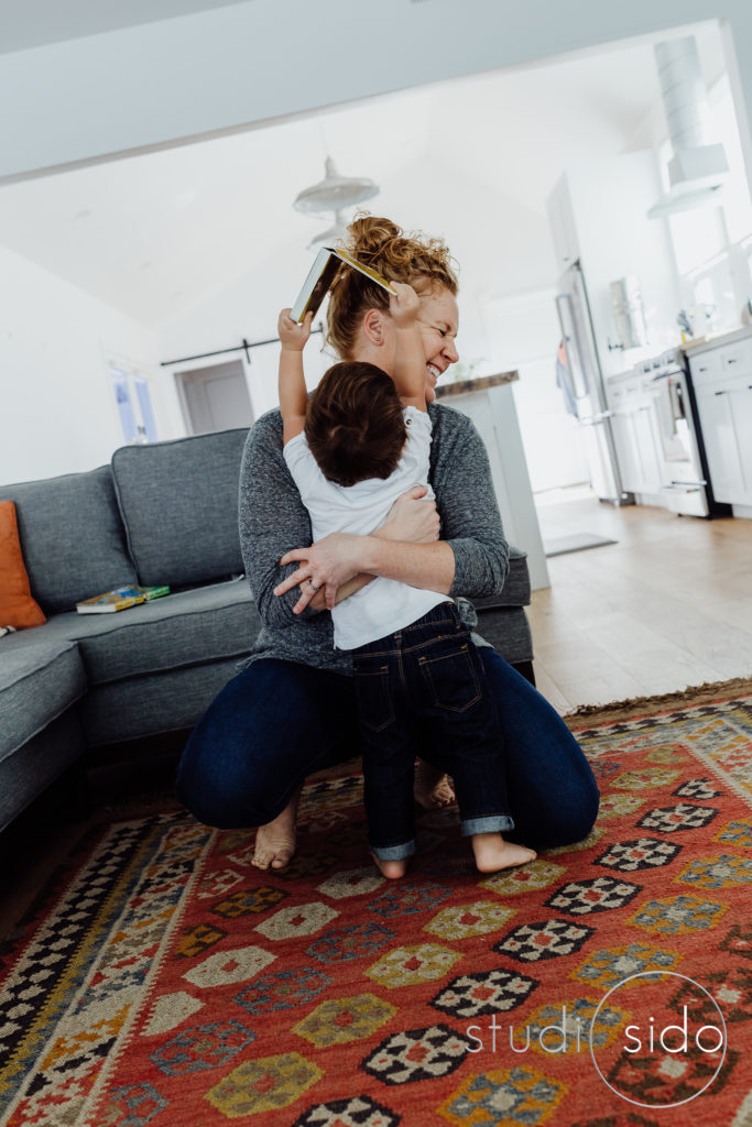 a little boy plays with his mom in their home in LA, CA