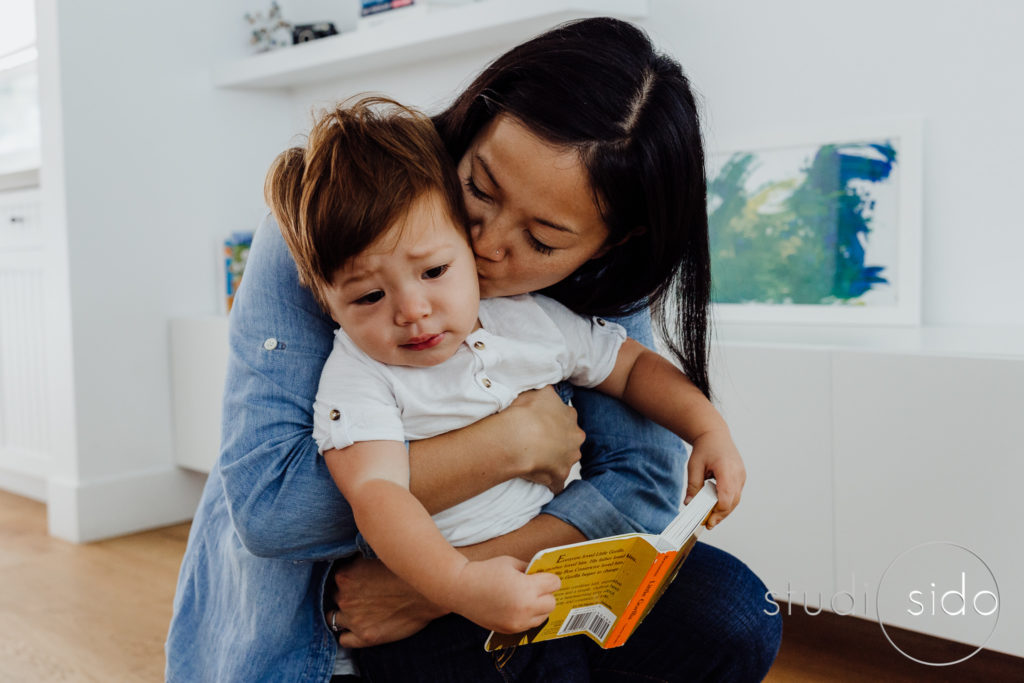 mom kisses her toddler in their home in Los Angeles, CA