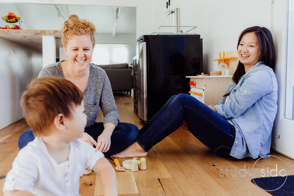 Moms sit on the floor and play on the floor with their son in their home in LA, CA