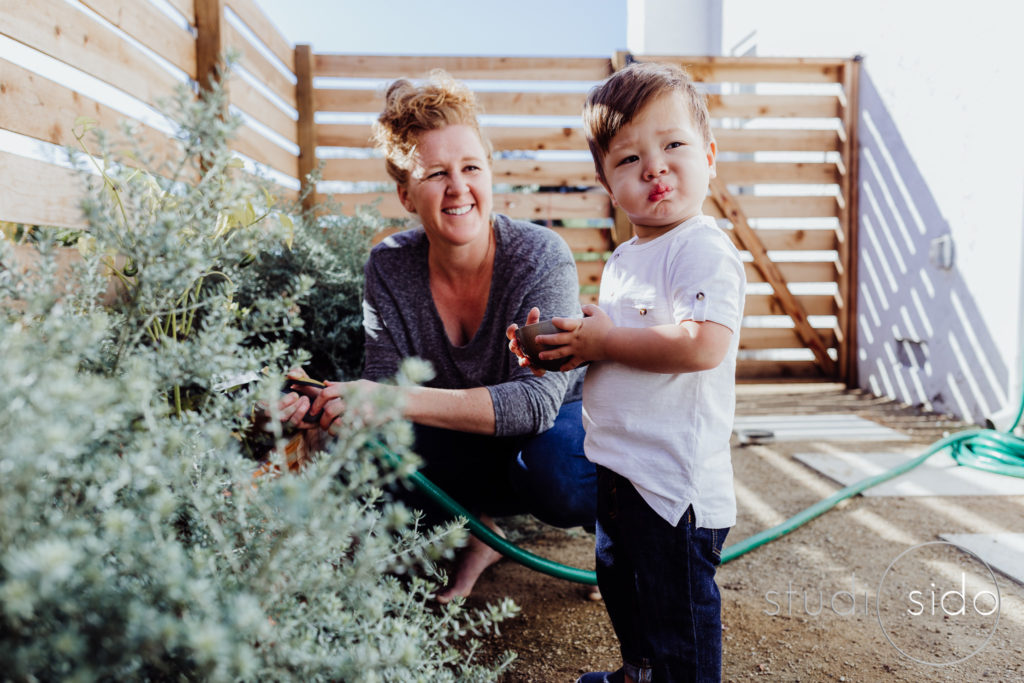 mom and son in their garden in Los Angeles, CA