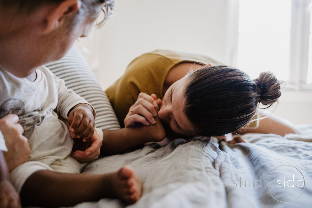 Mom kisses her son's little foot in their home in Silver Lake, Los Angeles, CA