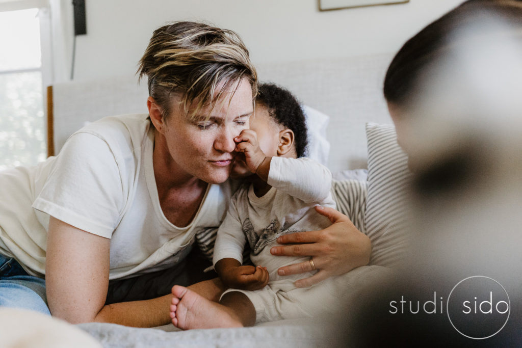 Little boy kisses mama's face in their home in LA, CA