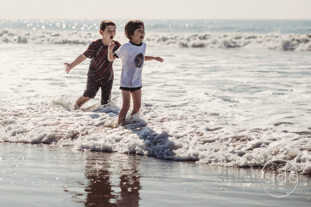 Children Happily Playing on Beach