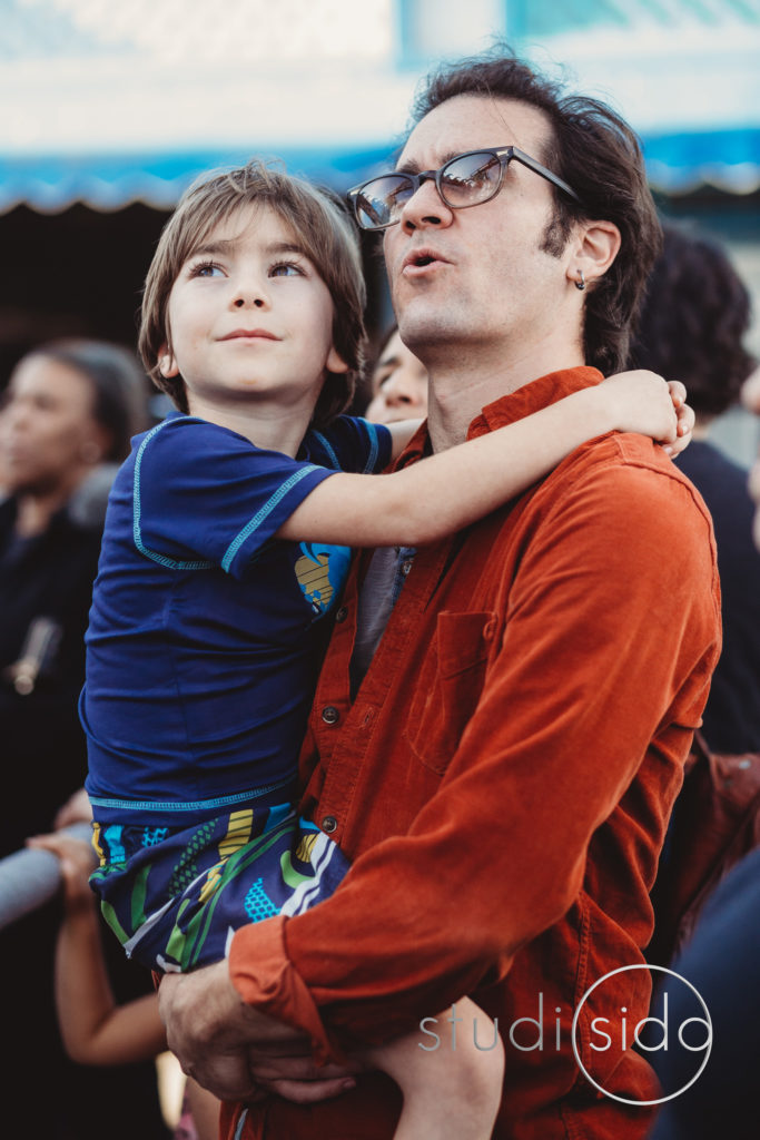 Dad Holding Young Son And Looking Towards Sky