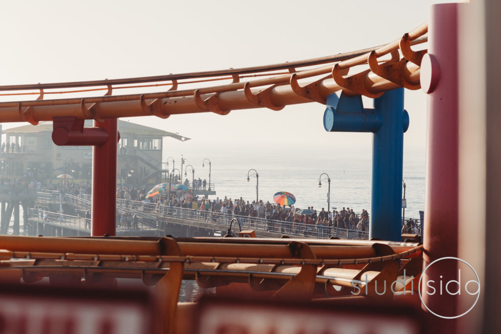 Rollercoaster in front of pier in California