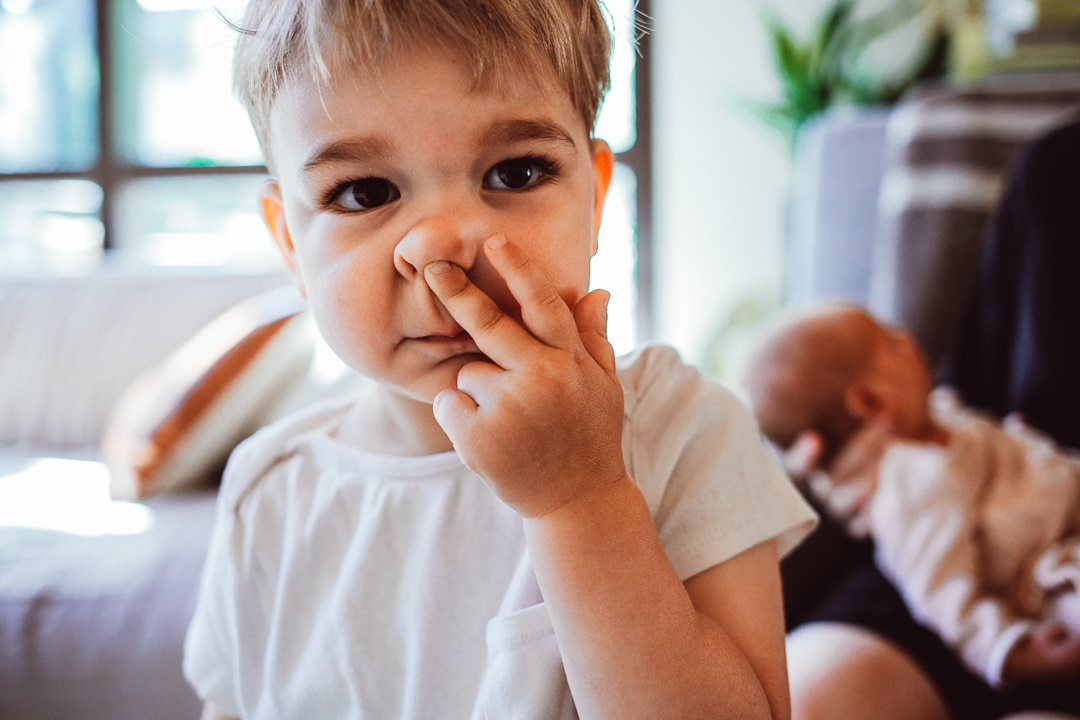 Young Boy With Two Fingers on Nose