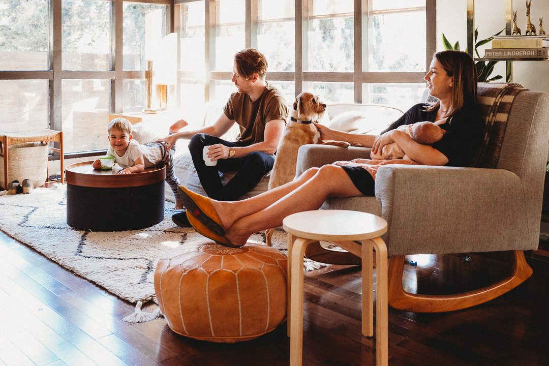 Casual Family Photo in Living Room With Toddler, Newborn, and Dog