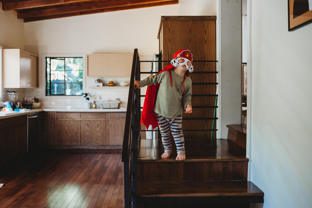 Toddler in Costume Walking Down Stairs