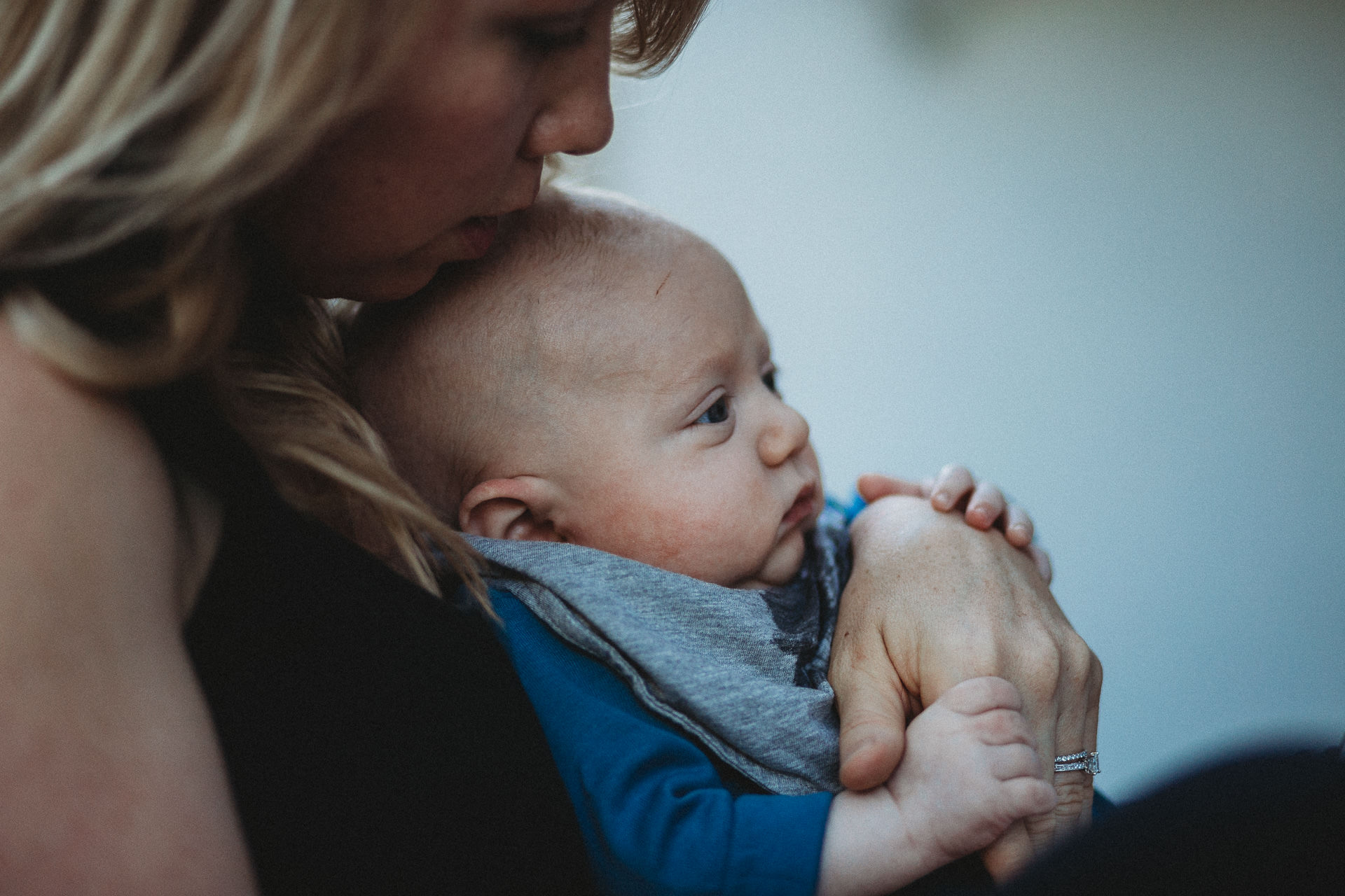 Baby sits in his mother's lap