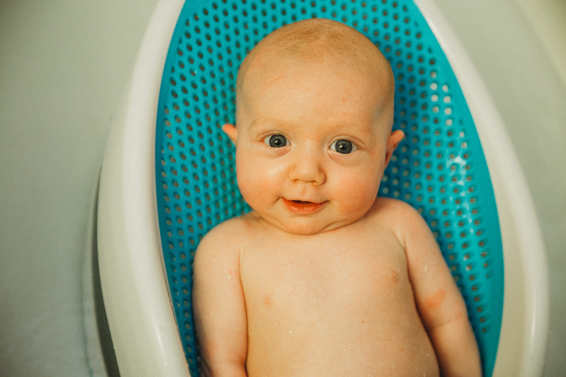 Super cute baby boy having a bath