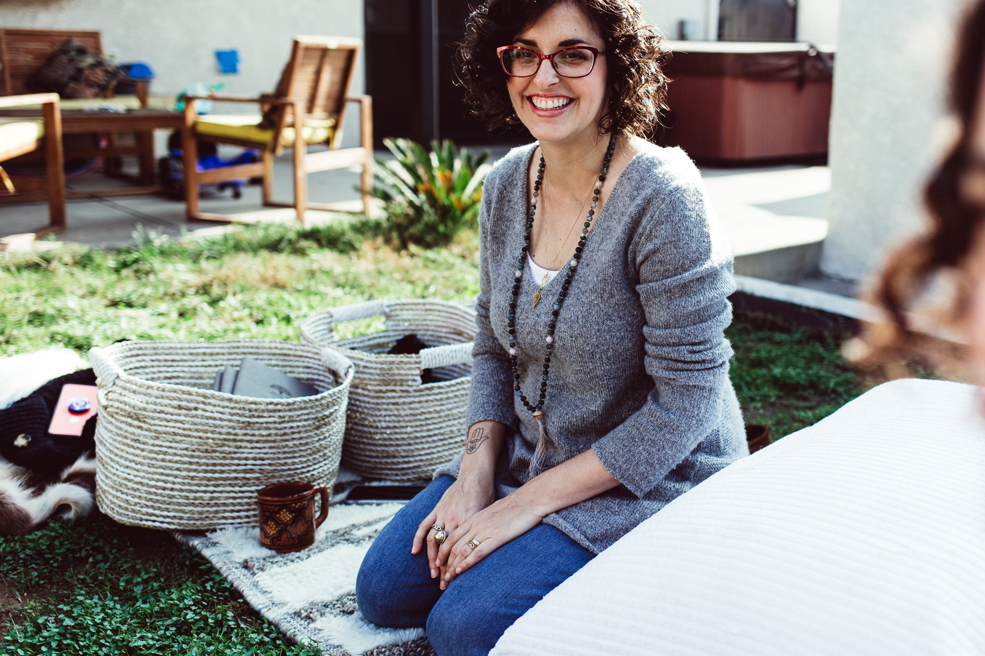 Woman Sitting Outside on Blanket With Baskets