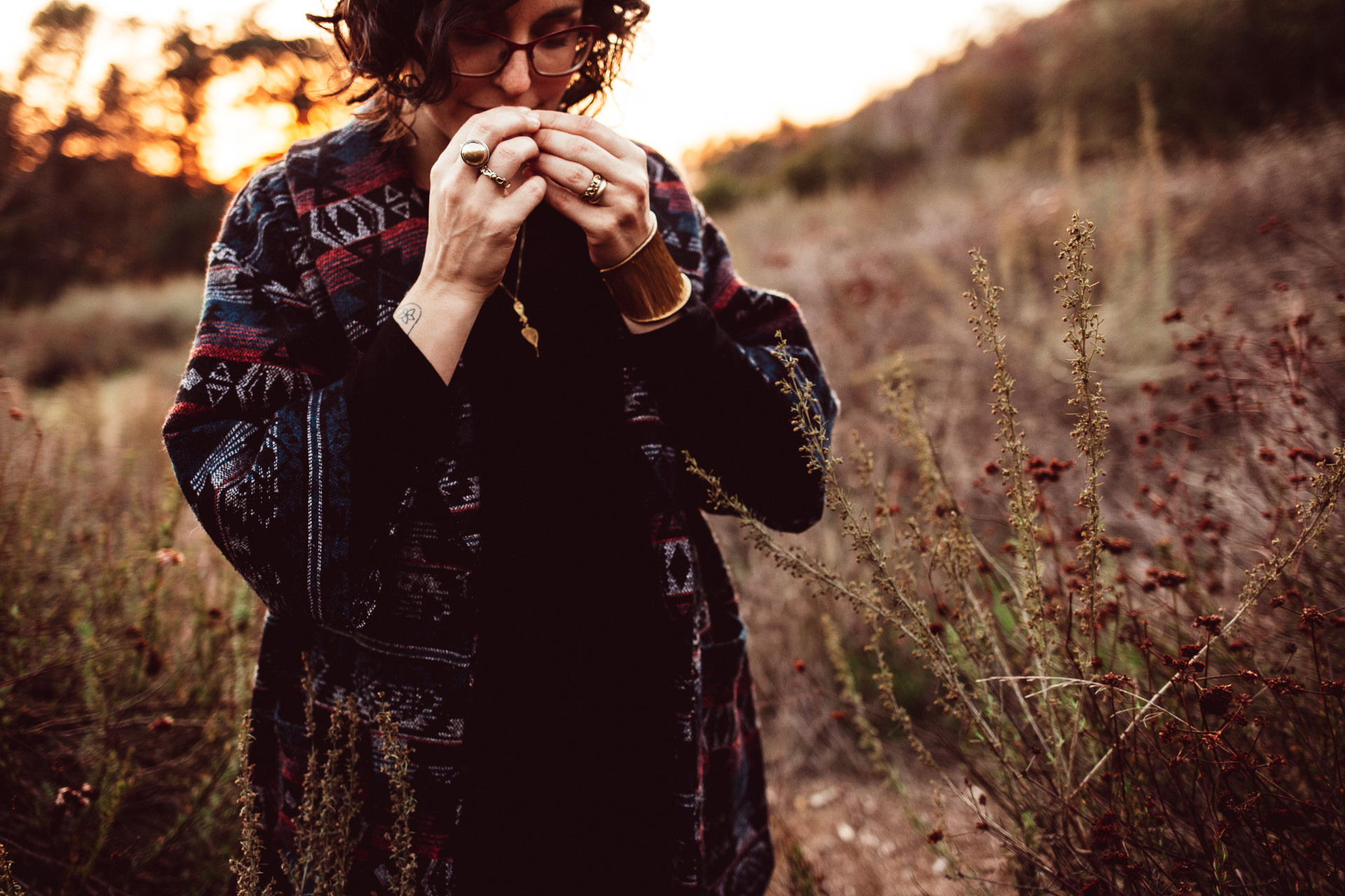 Woman Smelling Flowers Outside at Dusk