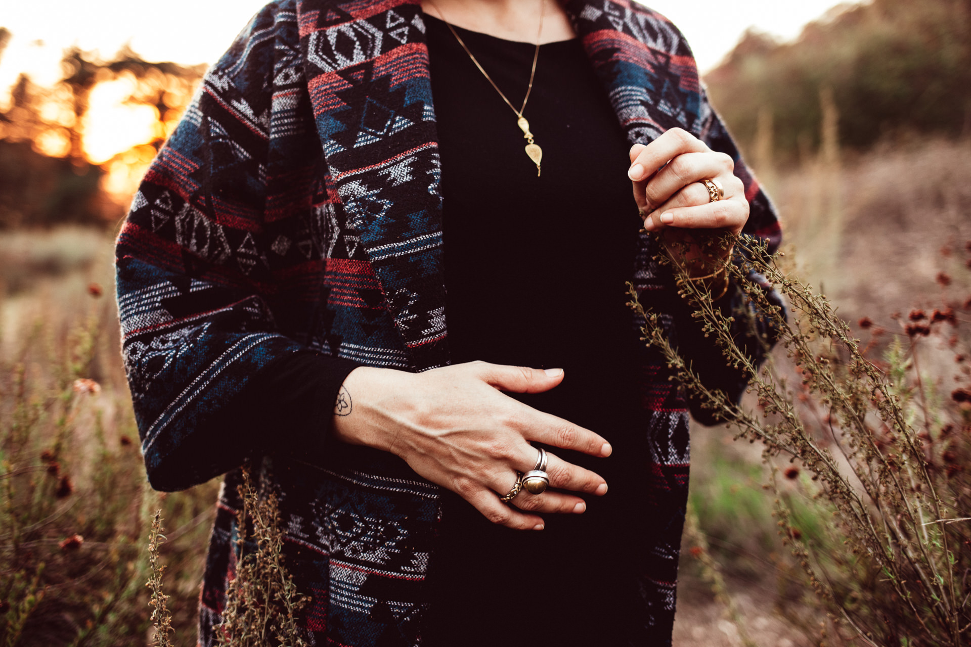 Close Up Photo Of Woman in Warm Coat Holding Fall Flowers