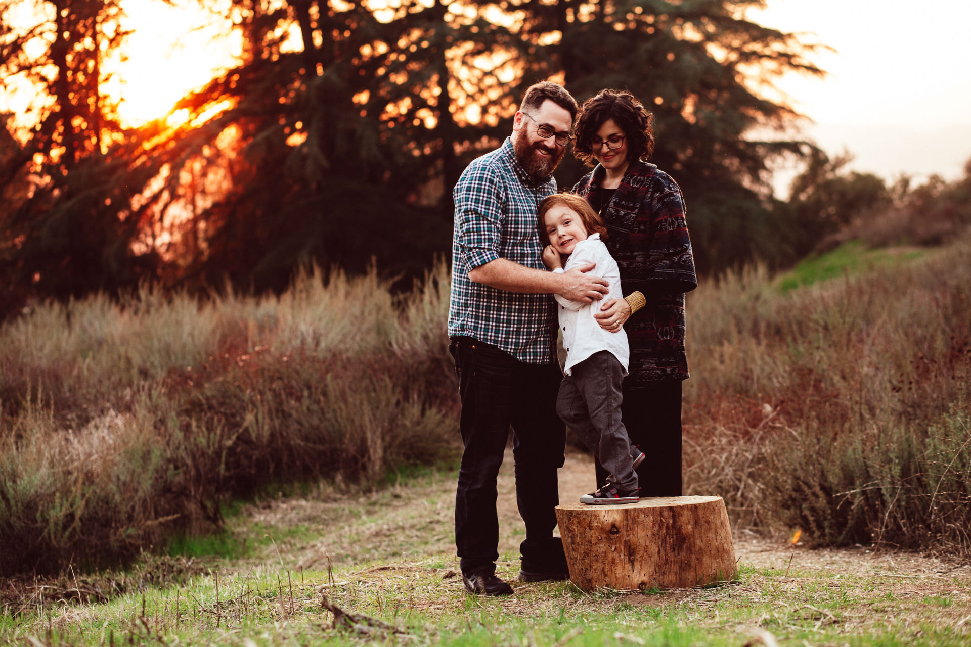 Young Family Of Three Posing Outside in Fall