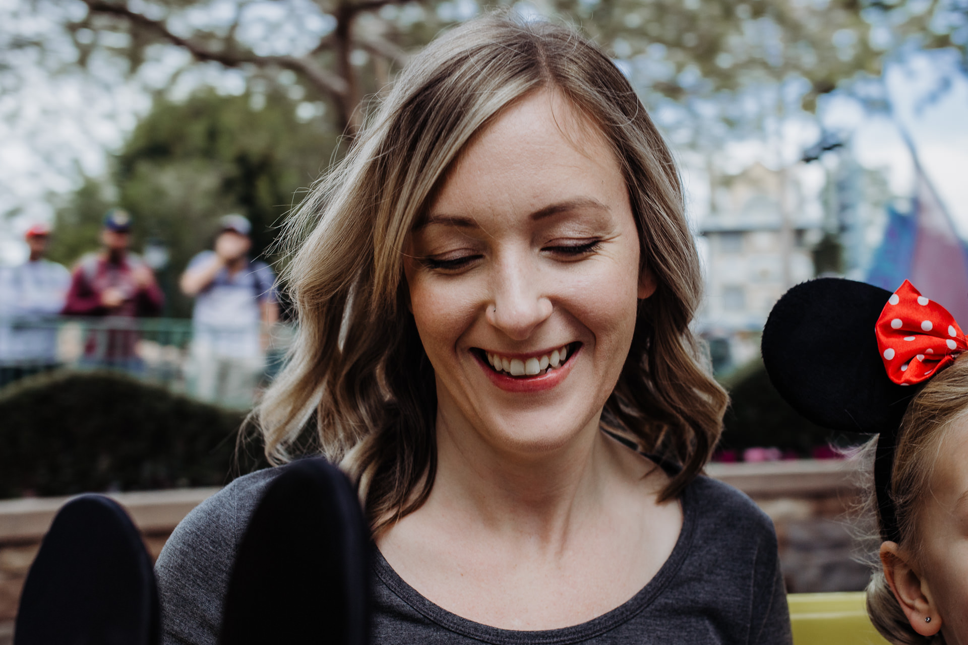 A mom rides the teacups with her family at Disneyland