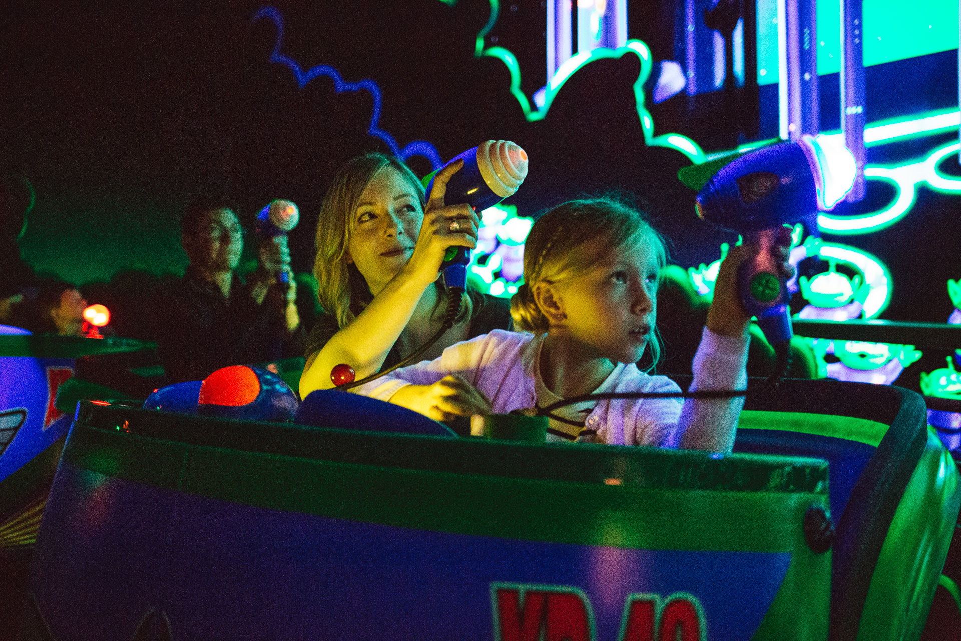 Mom and daughter ride the Astro Blasters ride at Disneyland