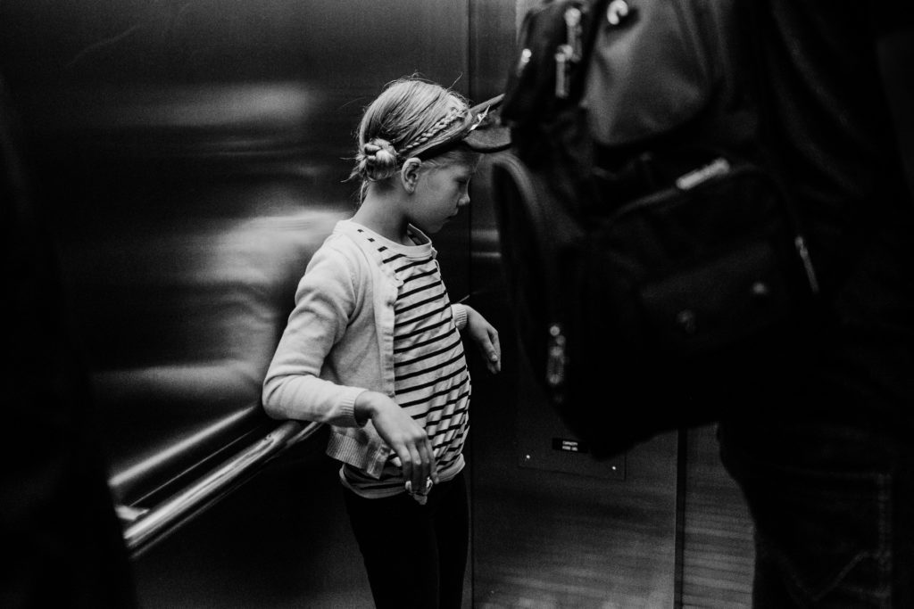 Black and white photograph of girl riding in elevator at Disneyland