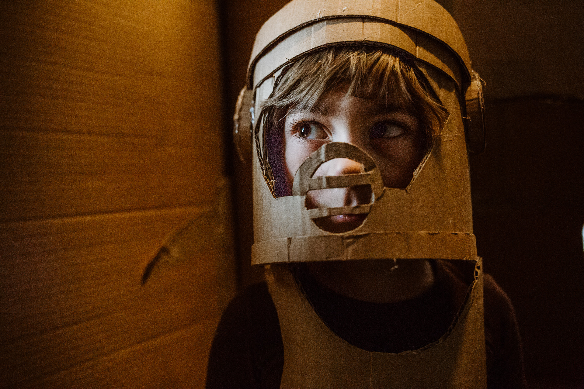 Young boy wears costume made of cardboard