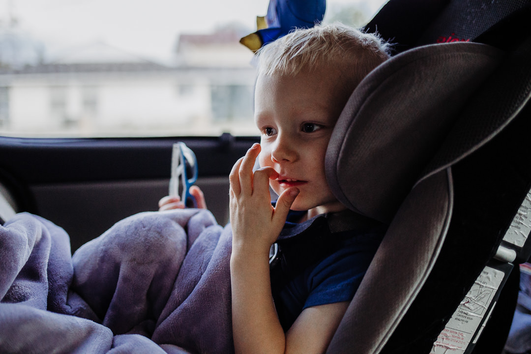 Little boy sits in anticipation as he drives to Disneyland