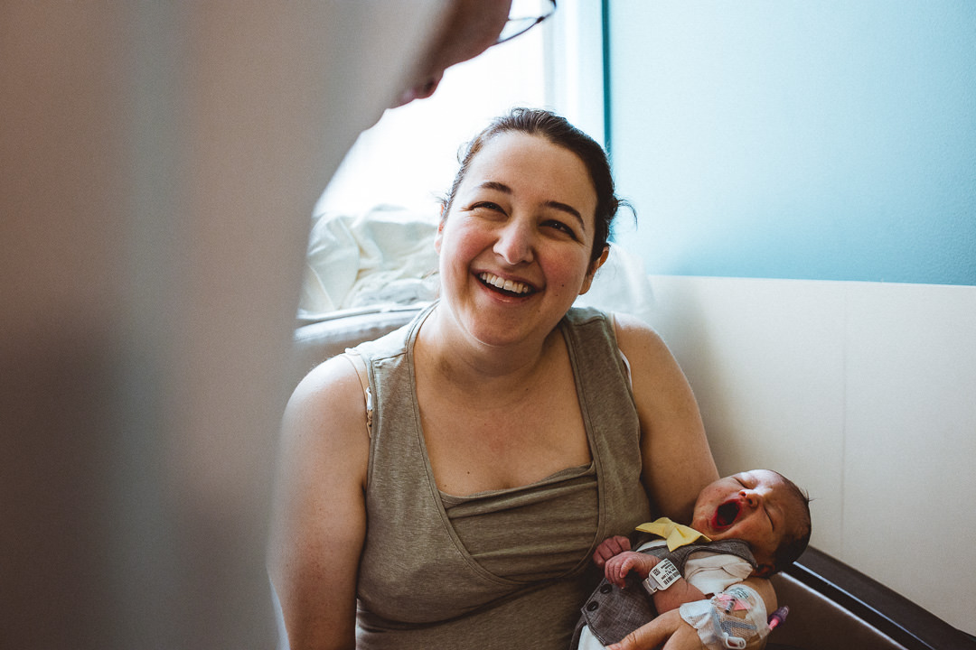 Newborn Baby Yawning Mom Smiling In Hospital