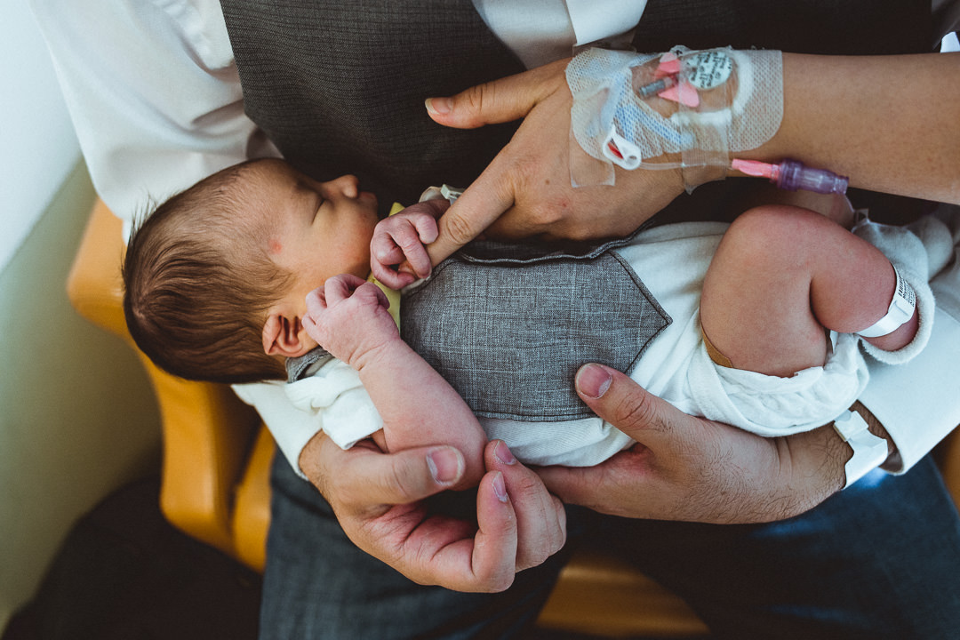 Newborn Baby Holding Parent's Finger In Hospital