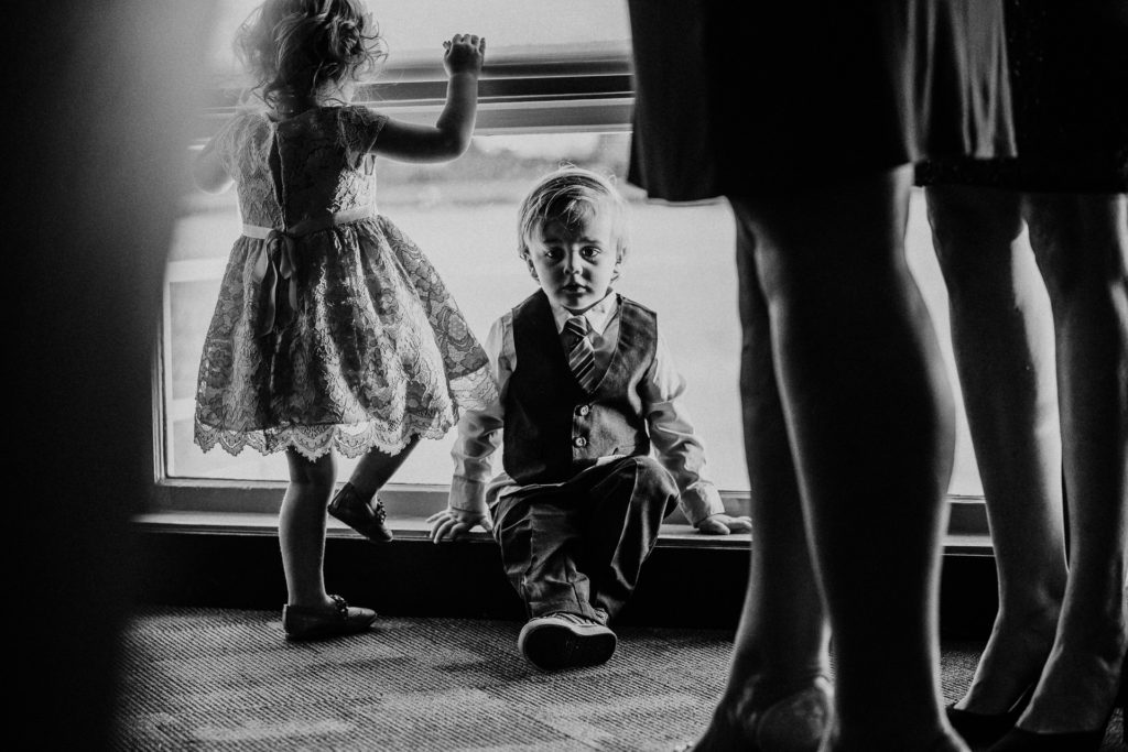 Little boy sits at the window at his grandparents 50th anniversary party in Long Beach, CA