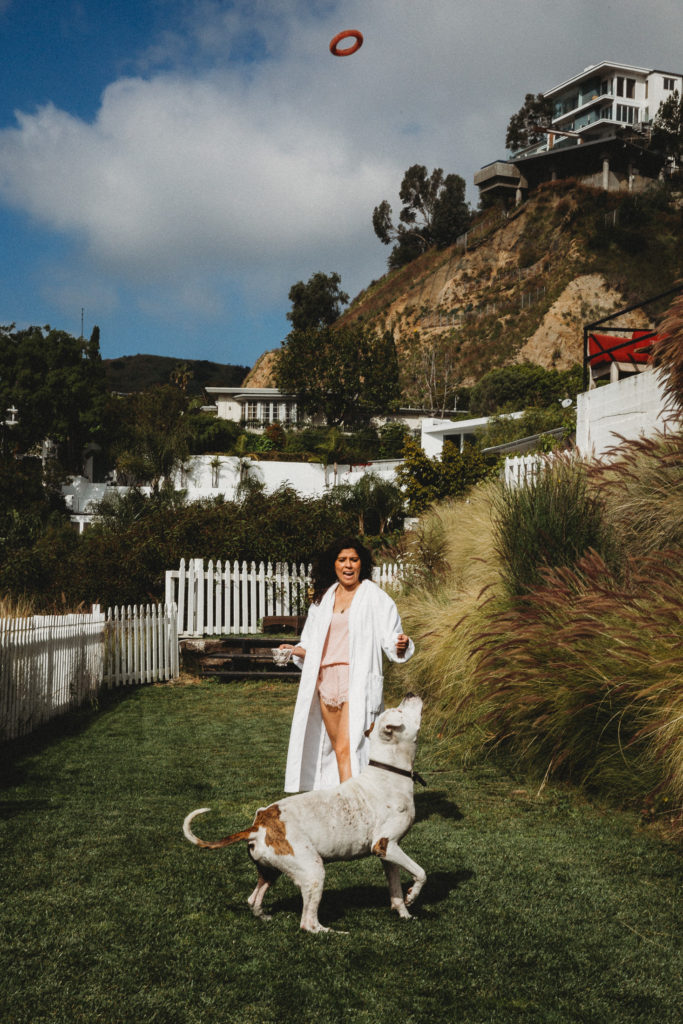 Woman Throwing Toy Outside in California With her Dog