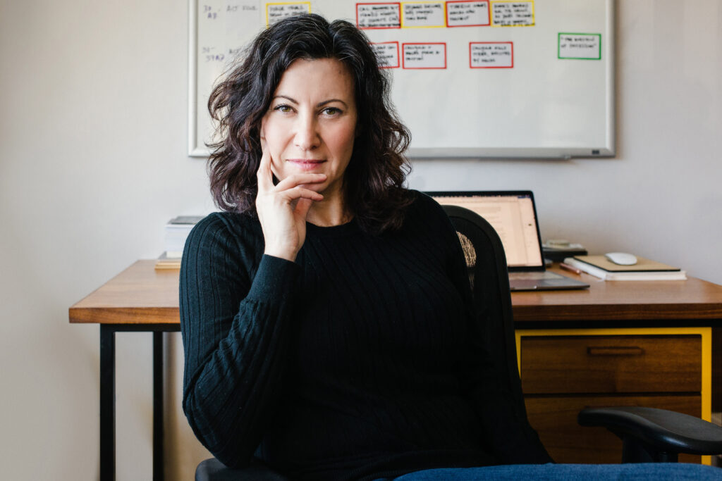 A writer sits in front of her desk