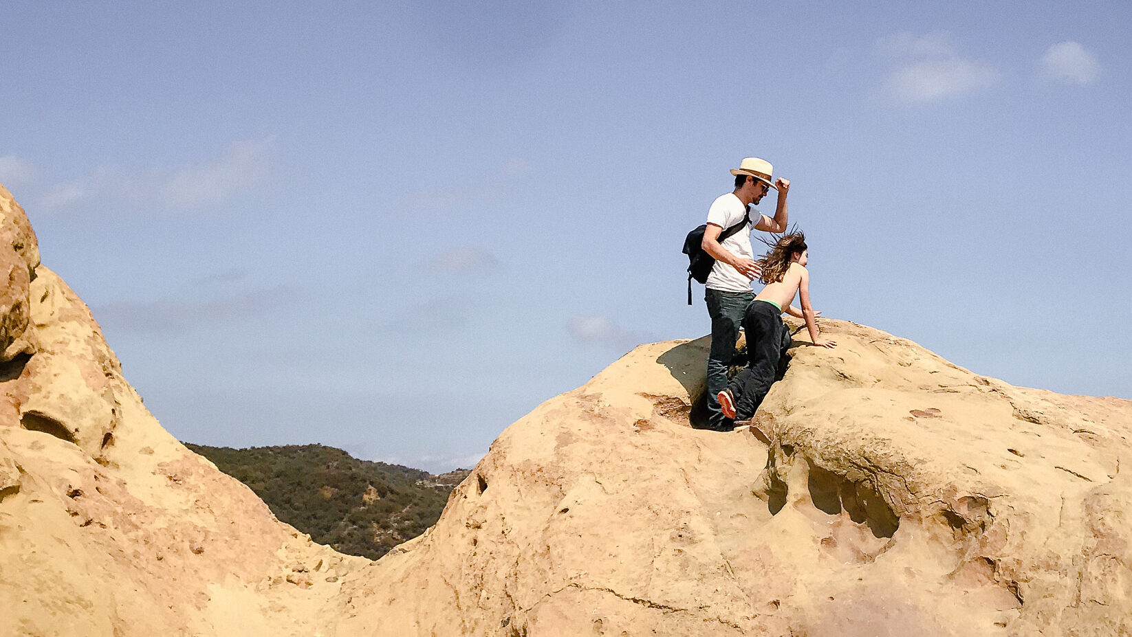 Father and son look out at the view from a high rock in Topanga Canyon, CA