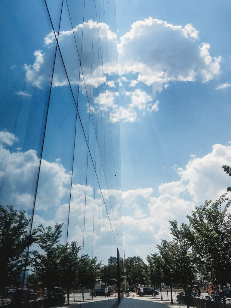 Clouds reflected in a glass building in NYC make a smiley face