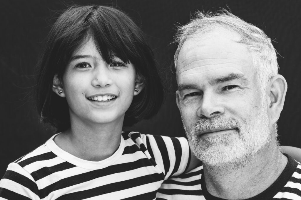 Dad and Young Child Smiling At Camera Black and White Photo