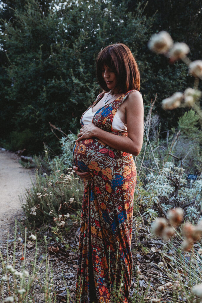 A pregnant woman surrounded by greenery in Eaton Canyon, Pasadena, CA