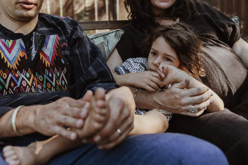 A family portrait - a boy snuggles between his dad and pregnant mom in Pasadena, CA