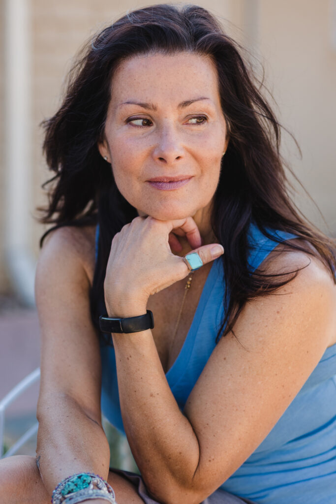 Woman in Blue Looking Sideways Outside